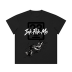 Black unisex crewneck t-shirt featuring the “Ink Pick Me” logo and abstract paint splatter design on the front.