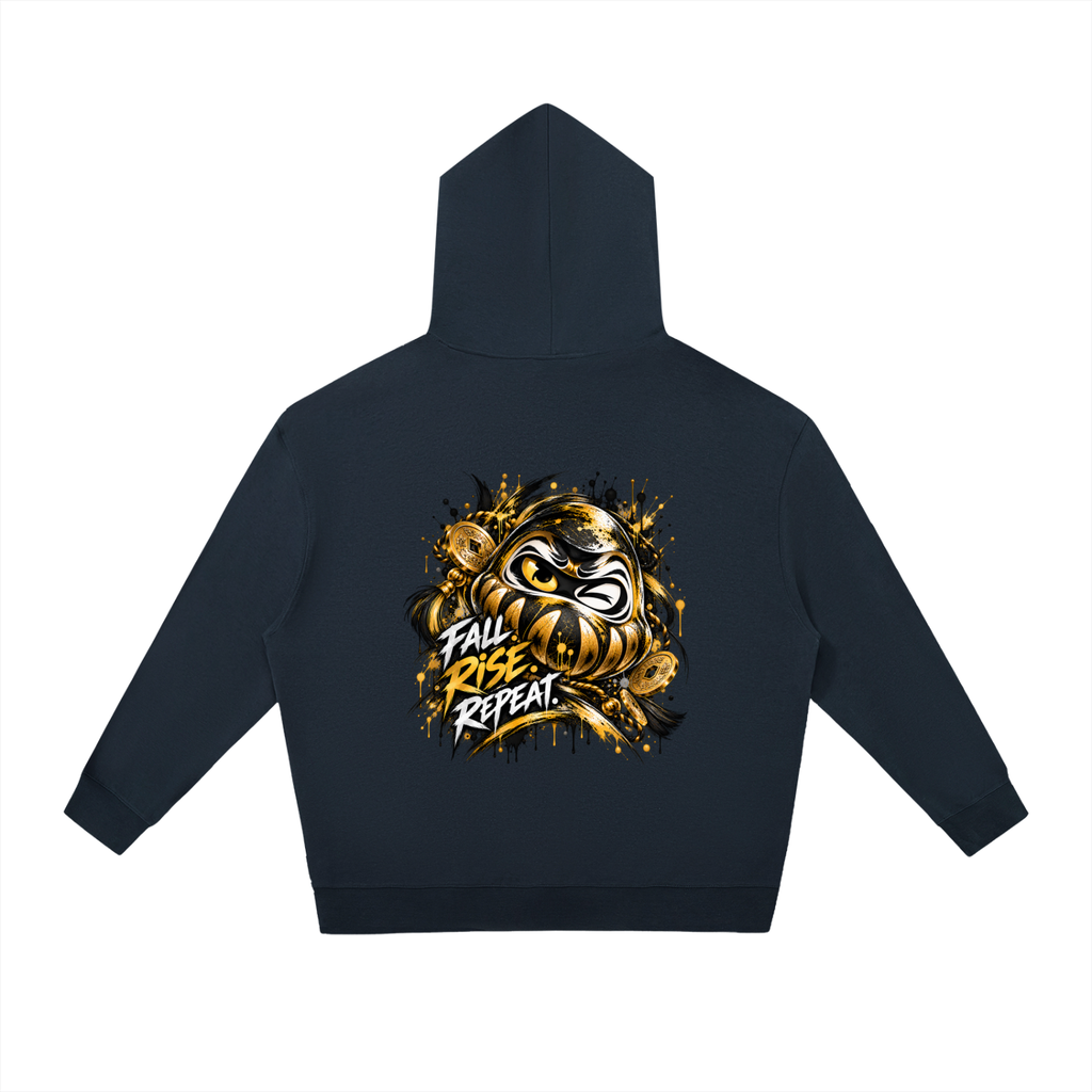 Oversized dark hoodie with a drawstring, featuring a gold graphic of a Daruma doll and the text "FALL RISE REPEAT" on the back.