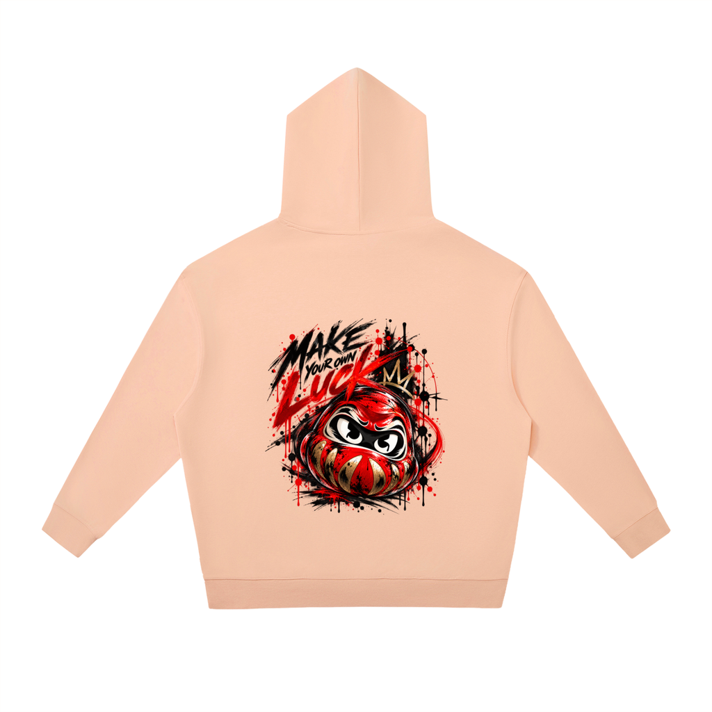 Daruma Luck graphic hoodie in soft peach, featuring an oversized fit and drop shoulders. Back design includes bold text and art.