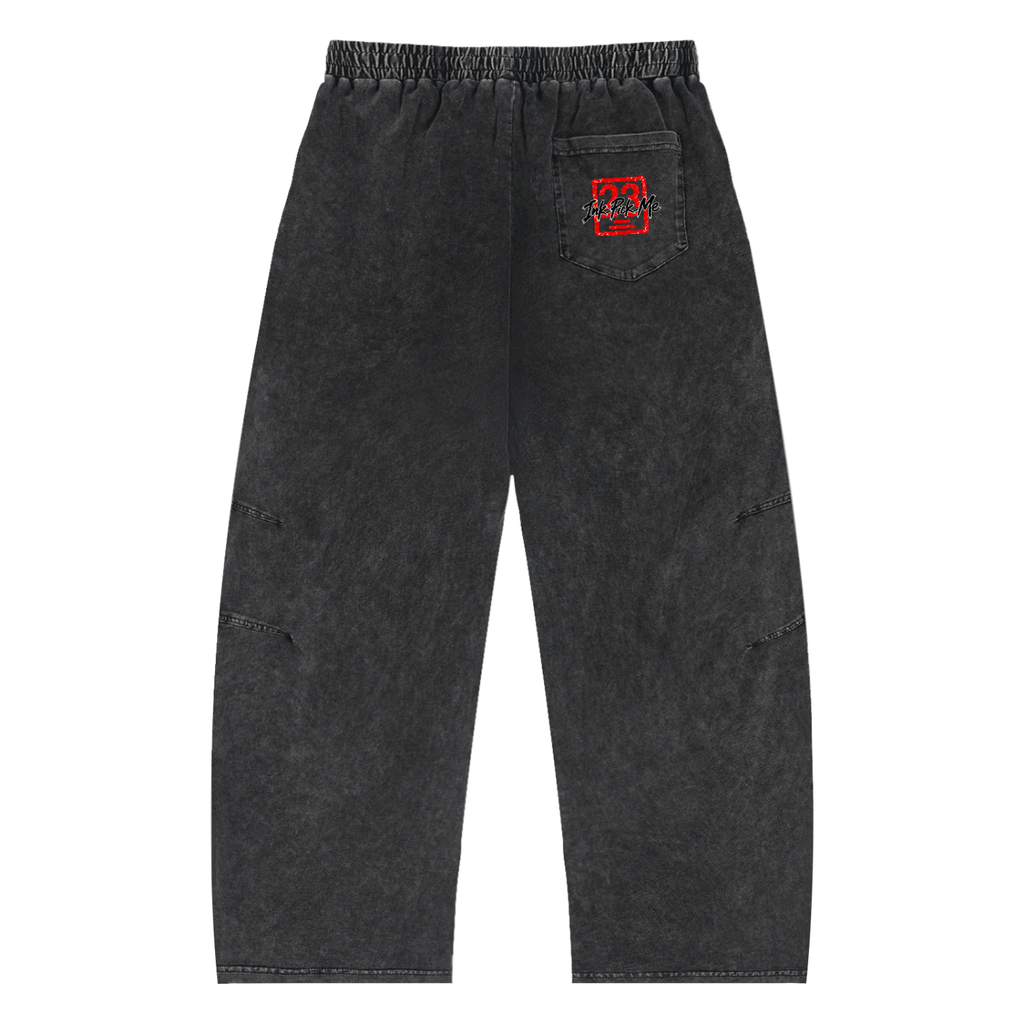 Snow Wash Drawstring Cotton Pants in a faded black color with side pockets and elastic waistband, featuring a logo on the back.