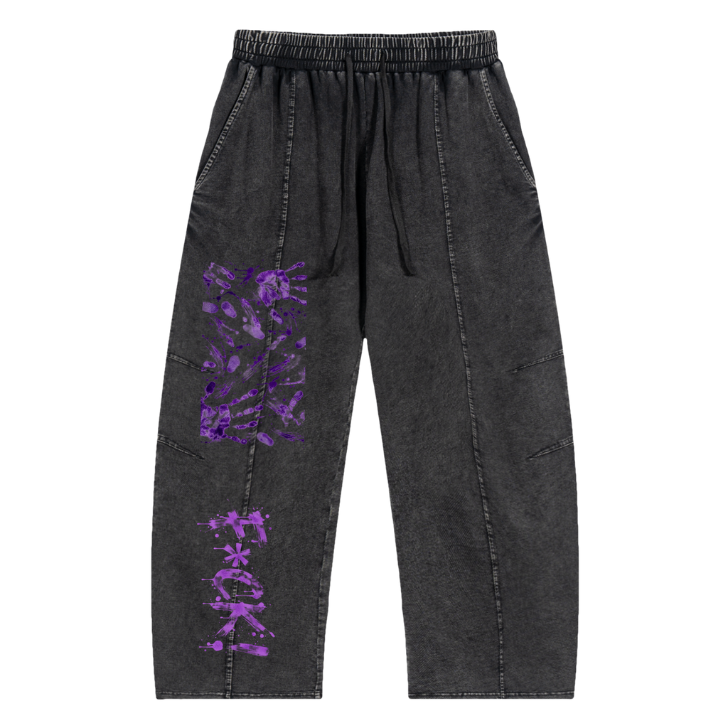 Black pants with a relaxed fit, featuring purple graphic stains and text. Designed for a streetwear style.