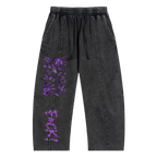 Black pants with a relaxed fit, featuring purple graphic stains and text. Designed for a streetwear style.