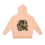 Oversized peach hoodie with a gold Daruma graphic and "FALL RISE REPEAT" text, featuring a relaxed fit and kangaroo pocket.