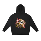 Black oversized hoodie featuring a colorful daruma graphic with pink flowers and the words "Love Purity" on the back.