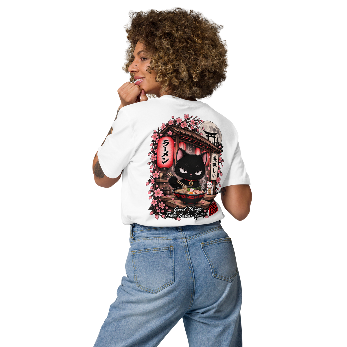 White t-shirt featuring a graphic of a black cat in a ramen shop, surrounded by cherry blossoms and Japanese text.